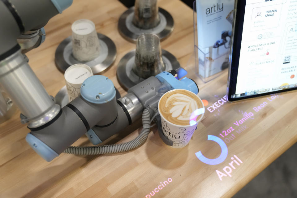 The Artly barista robot serves a drink during the CES tech show Wednesday, Jan. 10, 2024, in Las Vegas. (AP Photo/Ryan Sun)