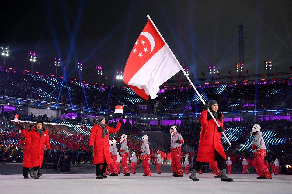 <p>Flag bearer Cheyenne Goh of Singapore and teammates enter the stadium during the Opening Ceremony of the PyeongChang 2018 Winter Olympic Games at PyeongChang Olympic Stadium on February 9, 2018 in Pyeongchang-gun, South Korea. (Photo by Matthias Hangst/Getty Images) </p>