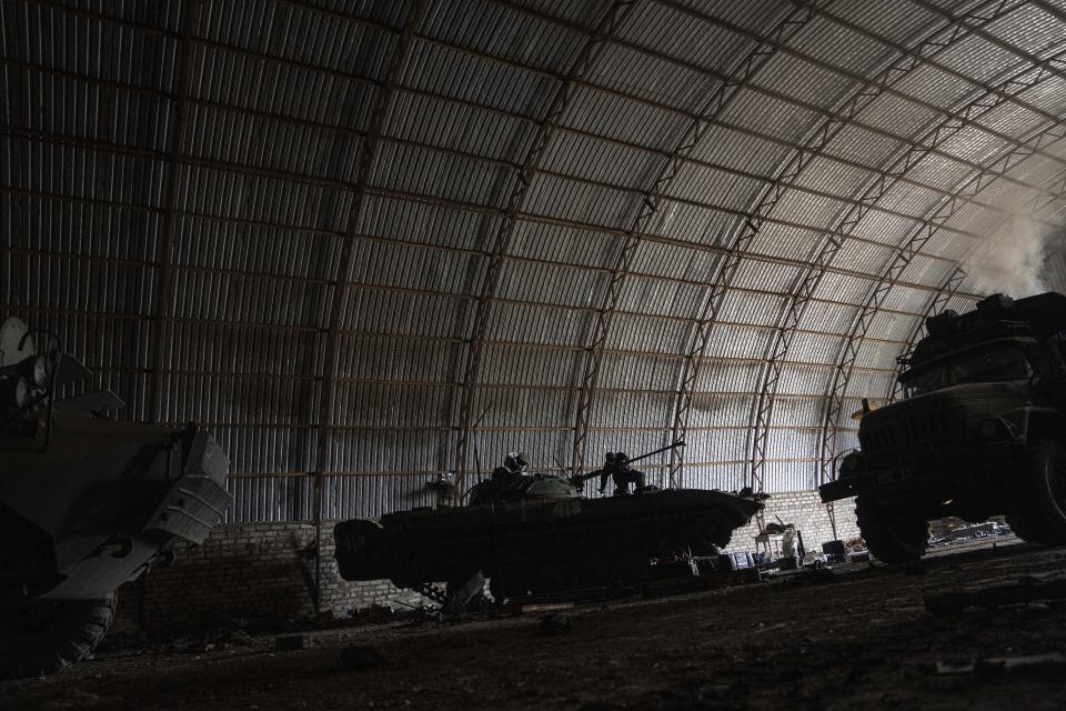 A Ukrainian serviceman fixes an APC's engine at the temporary base not far from the frontline in Donetsk region, Ukraine, Saturday, March 18, 2023. (AP Photo/Evgeniy Maloletka)