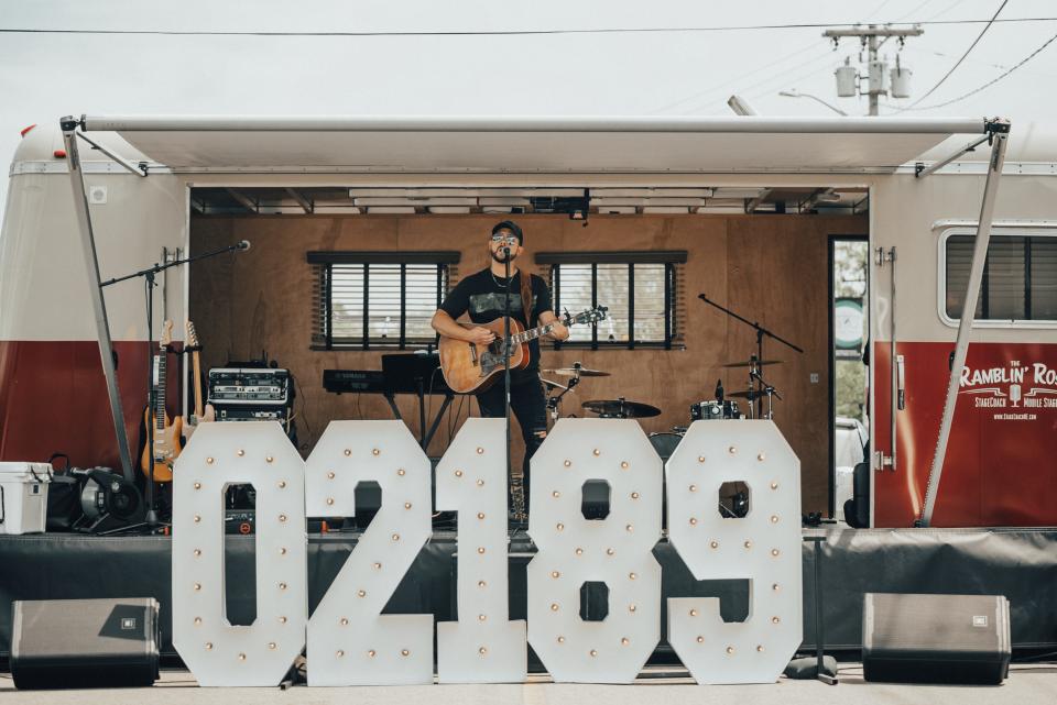 Weymouth residents listen to live music in Jackson Square on Saturday, May 14, 2022, during the first of several village-centric events celebrating Weymouth's 400th anniversary.