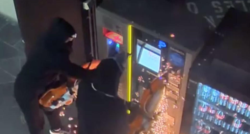 Two people try to break into a parking ticket machine at Westfield Belconnen on August 2 with chainsaws.