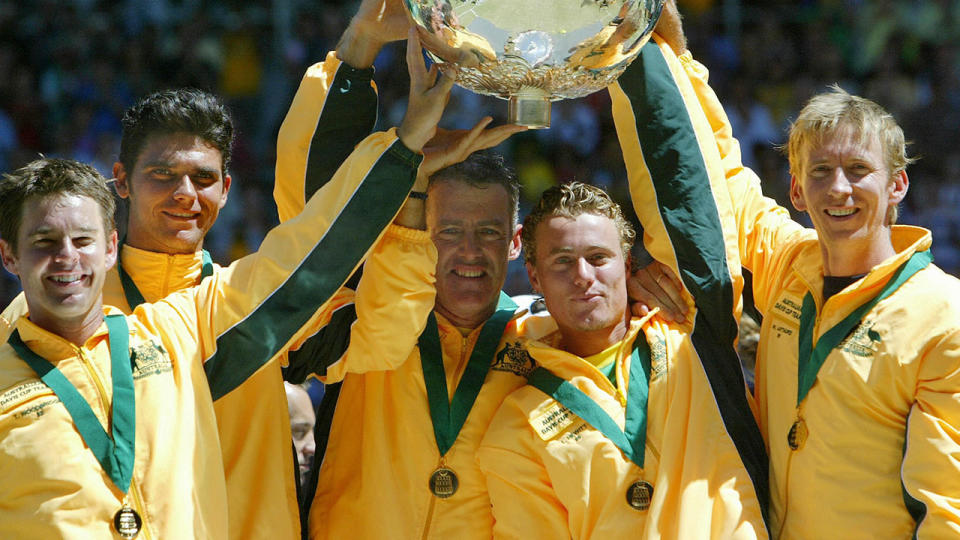 Australian’s team (L to R) Todd Woodbridge, Mark Philippoussis, captain John Fitzgerald, Lleyton Hewitt and Wayne Arthurs hold the Davis Cup, after winning against Spain at Rod Laver Arena in Melbourne, 30 November 2003. AFP PHOTO/ Christophe SIMON (Photo credit should read CHRISTOPHE SIMON/AFP/Getty Images)