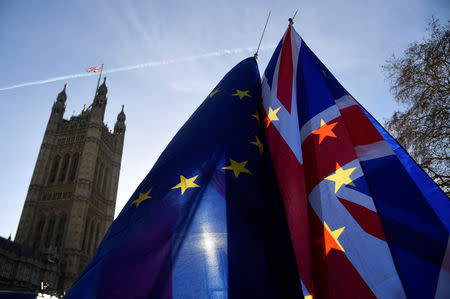 FILE PHOTO: Demonstrators hold EU and Union flags during an anti-Brexit protest opposite the Houses of Parliament in London, Britain, December 17, 2018. REUTERS/Toby Melville