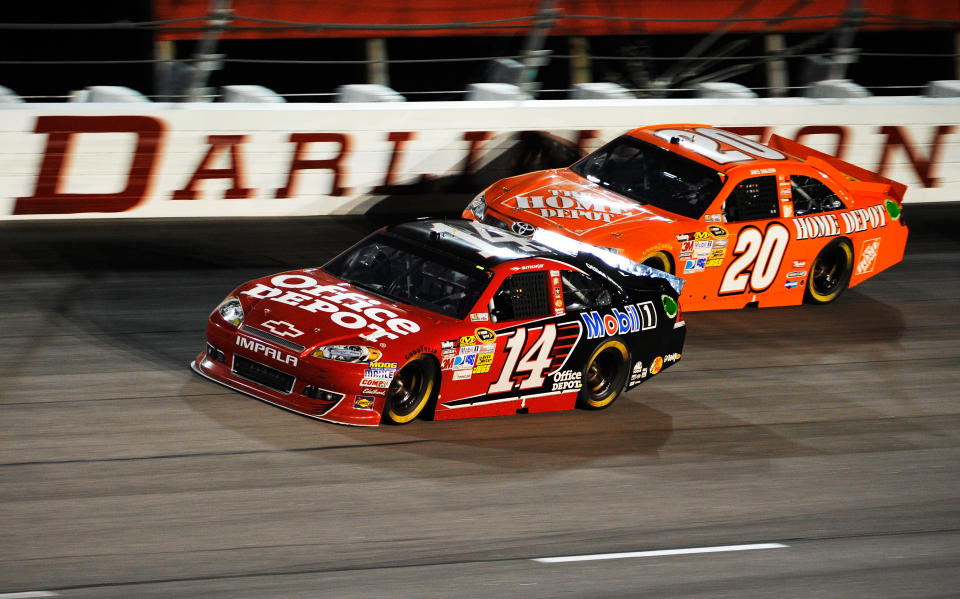 DARLINGTON, SC - MAY 12: Tony Stewart, driver of the #14 Office Depot/Mobil 1 Chevrolet, leads Joey Logano, driver of the #20 The Home Depot Toyota, during the NASCAR Sprint Cup Series Bojangles' Southern 500 at Darlington Raceway on May 12, 2012 in Darlington, South Carolina. (Photo by Rainier Ehrhardt/Getty Images for NASCAR)