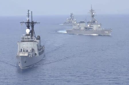 Japanese Maritime Self-Defence Force's destroyers Harusame (DD-102) and Amagiri (DD-154 behind Harusame) sail near Philippine warship BRP Ramon Alcaraz (PF 16) as they make a formation during their joint naval drill in the South China Sea, in this handout photo taken May 12, 2015 and released by the Maritime Staff Office of the Defense Ministry of Japan on May 13, 2015. REUTERS/Maritime Staff Office of the Defense Ministry of Japan/Handout via Reuters