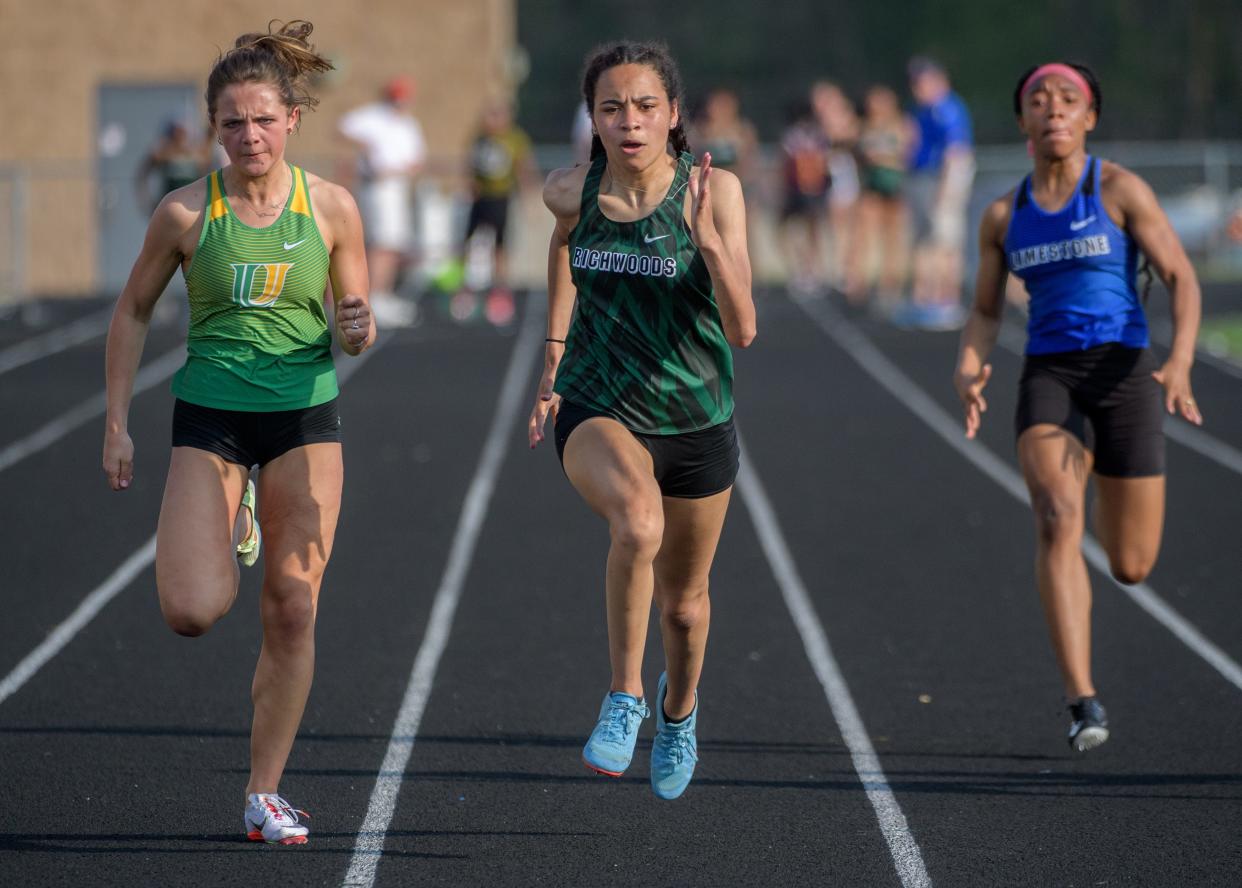 Richwoods freshman Lena Jackson, middle, battles Normal U-High's Anna Barr, left, in the 100-meter dash during the Class 2A Dunlap Sectional track and field meet  Wednesday, May 11, 2022 at Dunlap High School. Jackson beat Barr for first place in a time of :12.22. At far right is eighth-place finisher Limestone's Ranaisha Howard-Dunigan