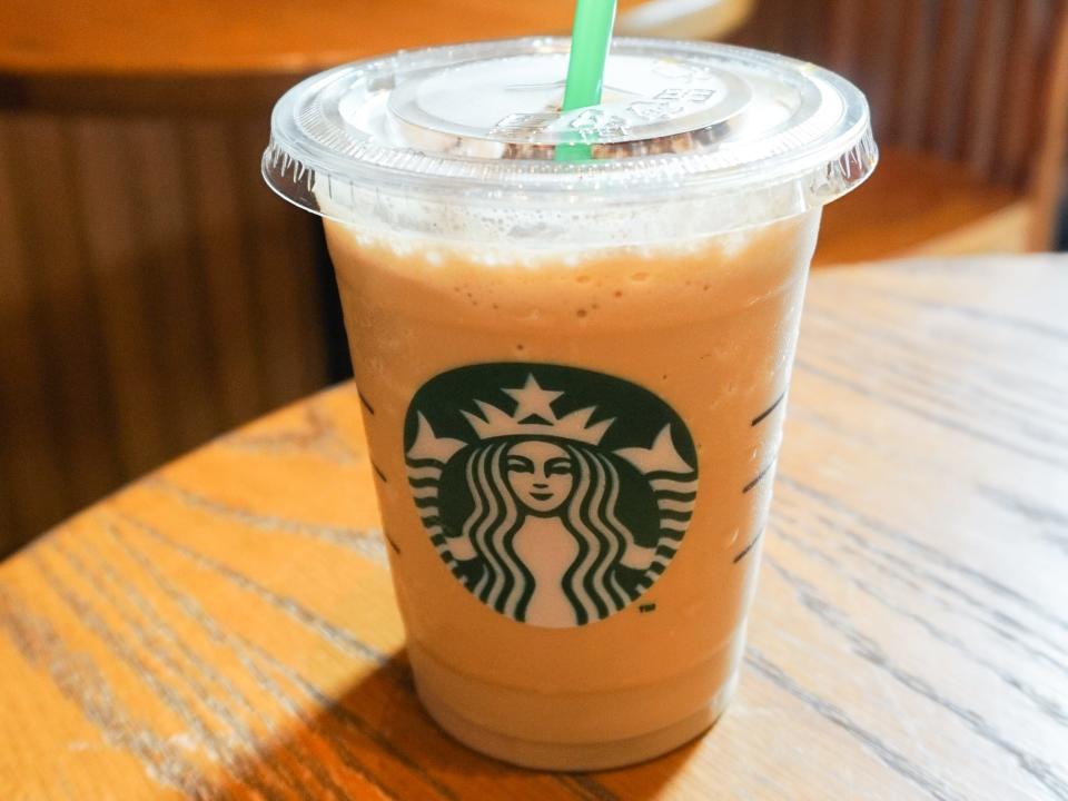 Starbucks cold brew with foam on top on a wooden table