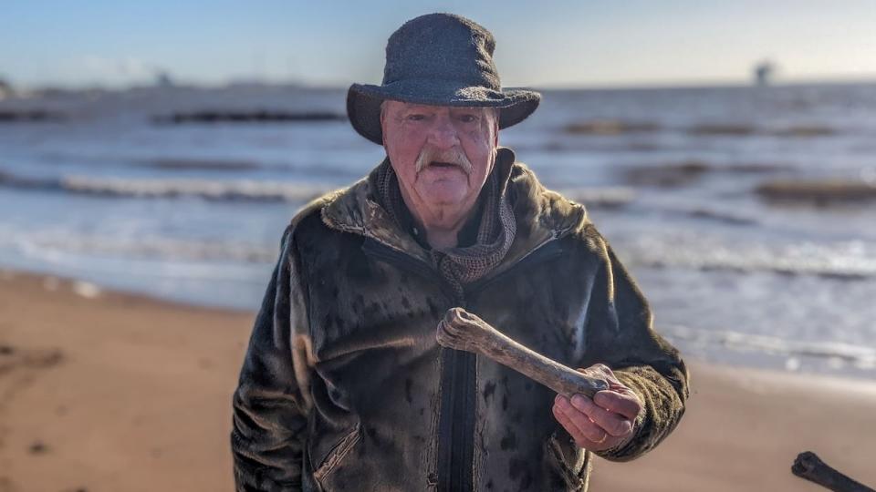 Ron Howse holds one of the bones that he found on Souris beach in August 2023.