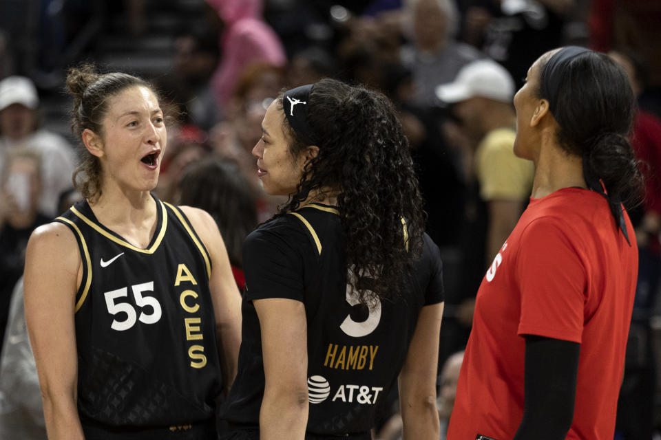 Las Vegas Aces forward Theresa Plaisance (55), forward Dearica Hamby (5) and forward A'ja Wilson, right, celebrate after winning a WNBA basketball game against the Phoenix Mercury, Saturday, May 21, 2022, in Las Vegas. (AP Photo/Ellen Schmidt)