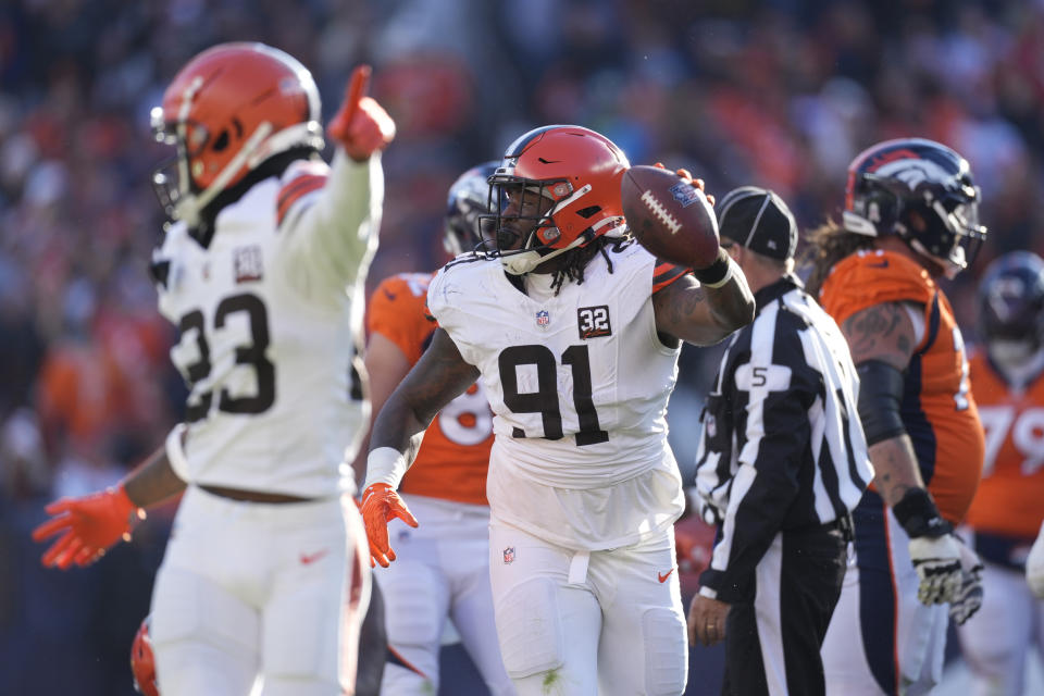 Cleveland Browns defensive end Alex Wright celebrates after recovering a fumble by Denver Broncos quarterback Russell Wilson during the first half of an NFL football game on Sunday, Nov. 26, 2023, in Denver. (AP Photo/David Zalubowski)