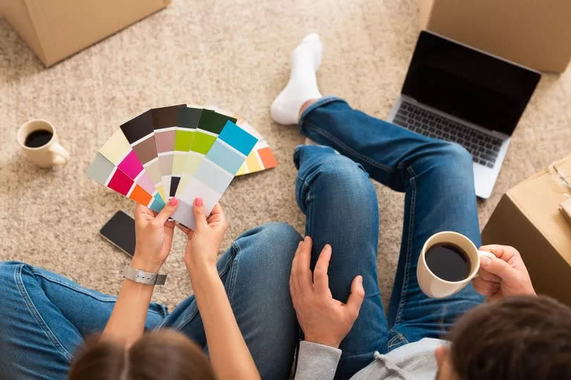 Generic stock photo of people looking at paint colour options. See PA Feature HOMES Kunle Barker. WARNING: This picture must only be used to accompany PA Feature HOMES Kunle Barker.