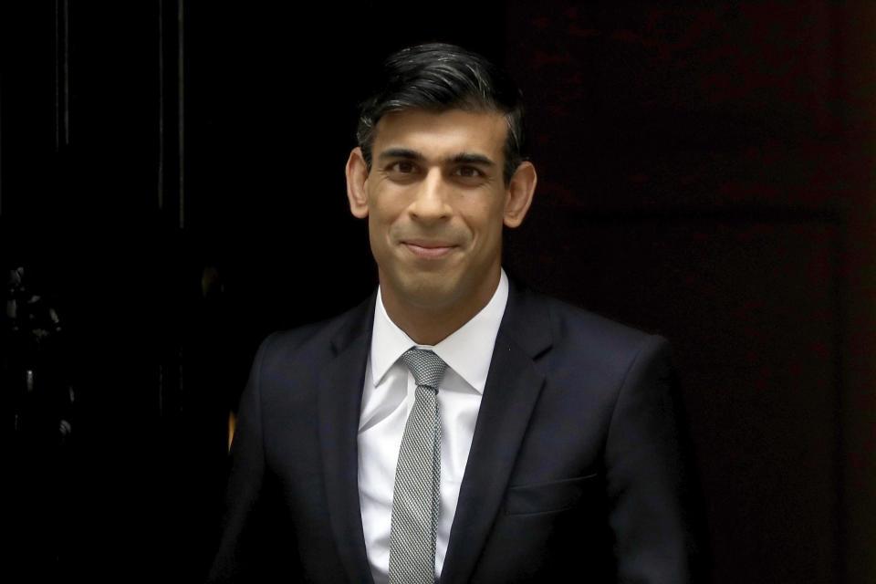 British Chancellor of the Exchequer Rishi Sunak leaves number 11 Downing Street, to deliver a financial announcement to the Houses of Parliament in London, Wednesday, July 8, 2020. British Treasury chief Rishi Sunak on Wednesday is set to announce a 2-billion-pound ($2.5 billion) program to create jobs for young people as the government tries to revive an economy battered by the COVID-19 pandemic. (AP Photo/Matt Dunham)