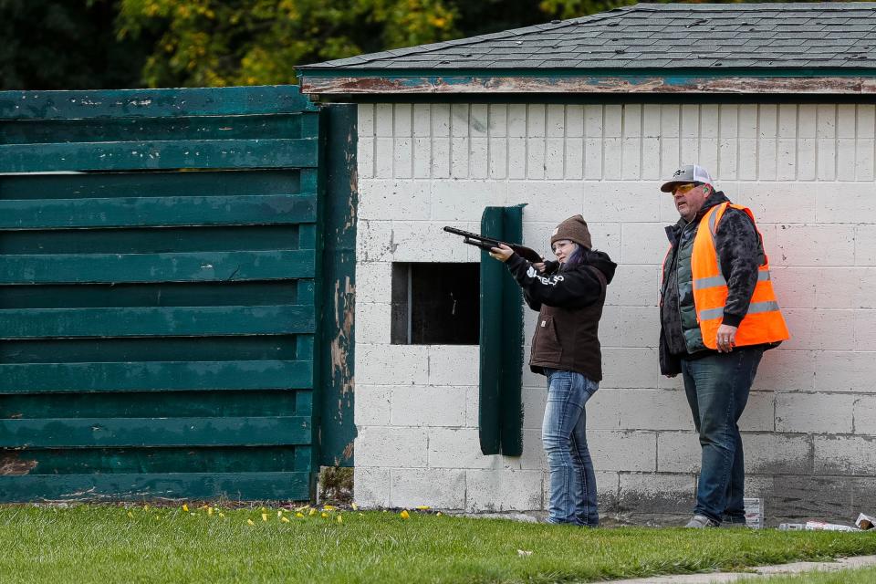 Khloe Hill, 16, of Pinconning, practices shooting skeet as instructor Gordon Van Putten watches during a hunter safety course at the Western Wayne County Conservation Association in Plymouth on Oct. 8, 2022.