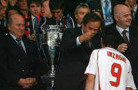 Athens, GREECE: AC Milan's forward Filippo Inzaghi receives his medal from former French player and president of the UEFA, Michel Platini, as Fifa's president Sepp Blatter looks on after the Champions League final football match against Liverpool at the Olympic Stadium, in Athens, 23 May 2007. AC Milan won 2-1. AFP PHOTO / MUSTAFA OZER (Photo credit should read MUSTAFA OZER/AFP via Getty Images)