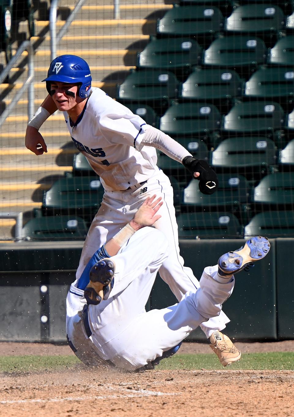 Park Vista William Bavaro (7) celebrates as Matthew Lashley (24) dives into home plate and scoring during their game with Plant in a boys 7A baseball state semi championship matchup in Fort Myers, Fla., Tuesday , May 23, 2023.  (Photo/Chris Tilley)