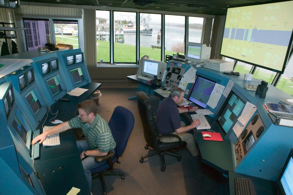 In a file photo from 2004, marine traffic controllers work inside a marine traffic control center of the U.S. Army Corps of Engineers in Buzzards Bay.