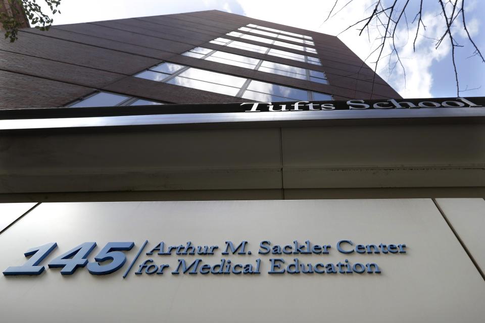 FILE - In this Sept. 25, 2019, file photo, a sign at an entrance to Tufts School of Medicine, in Boston, identifies the address as the Arthur M. Sackler Center for Medical Education. Tufts announced Thursday, Dec. 5, it will strip the Sackler name from all of its institutions. (AP Photo/Steven Senne, File)