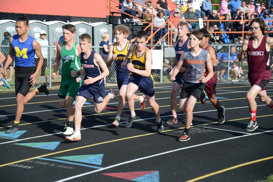 Runners jockey for position at the start of the 800 meters in the Tri-County Conference track and field championships at Summerfield Tuesday.
