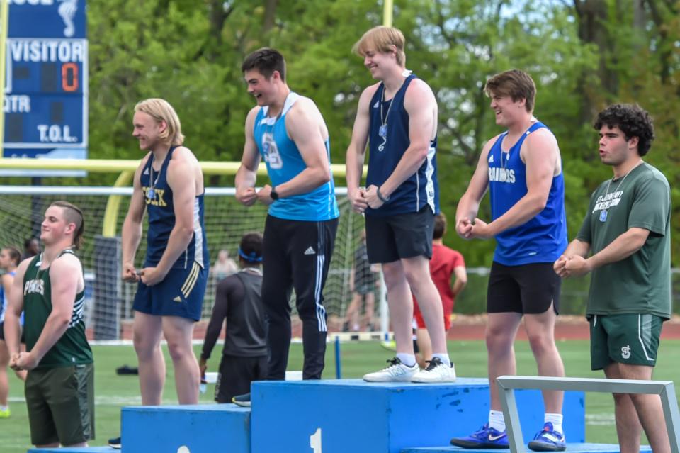 Burlington's Winslow Sightler stands at the top of the podium twice as he wins both the shot put and discus at the 51st annual Burlington High School Track and Field Invitational on Saturday.