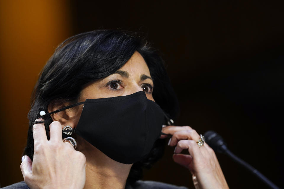 FILE - Dr. Rochelle Walensky, director of the Centers for Disease Control and Prevention, adjusts her face mask during a Senate Health, Education, Labor and Pensions Committee hearing on the federal coronavirus response on Capitol Hill in Washington, in this Thursday, March 18, 2021, file photo. Walensky says new mask-wearing guidance, coupled with higher rates of vaccination against COVID-19, could halt the current escalation of infections in “a couple of weeks.” The director of the Centers for Disease Control and Prevention told “CBS This Morning” she hopes more stringent mask-wearing guidelines and other measures won’t be necessary as the country heads into the fall. (AP Photo/Susan Walsh, Pool, File)