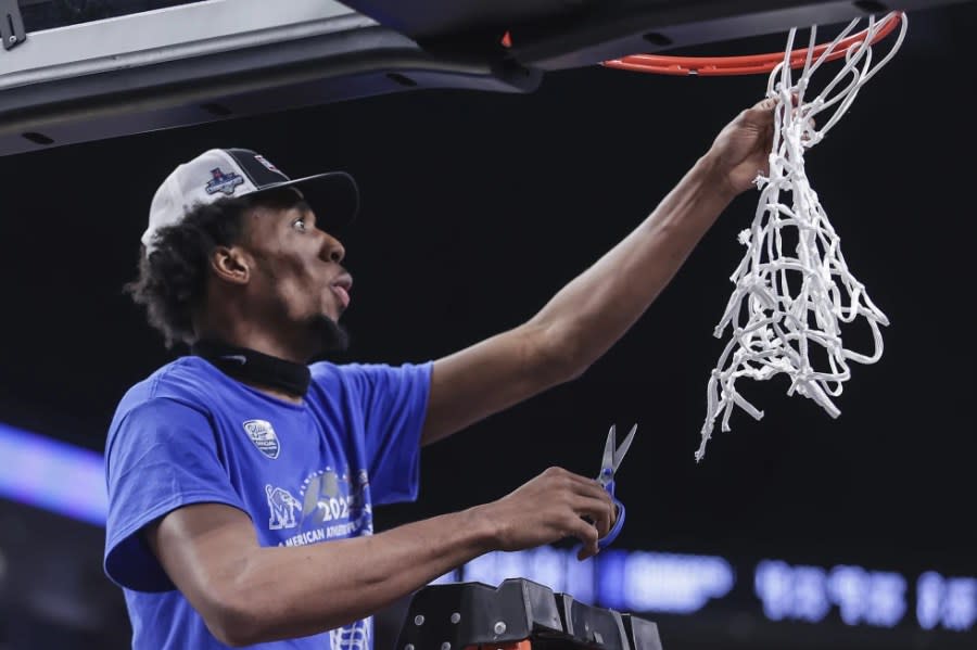 Memphis forward DeAndre Williams cuts down the net after the team’s win in the final against Houston in the American Athletic Conference men’s basketball tournament March 12, 2023, in Fort Worth, Texas. (Patrick Lantrip/Daily Memphian via AP, File)