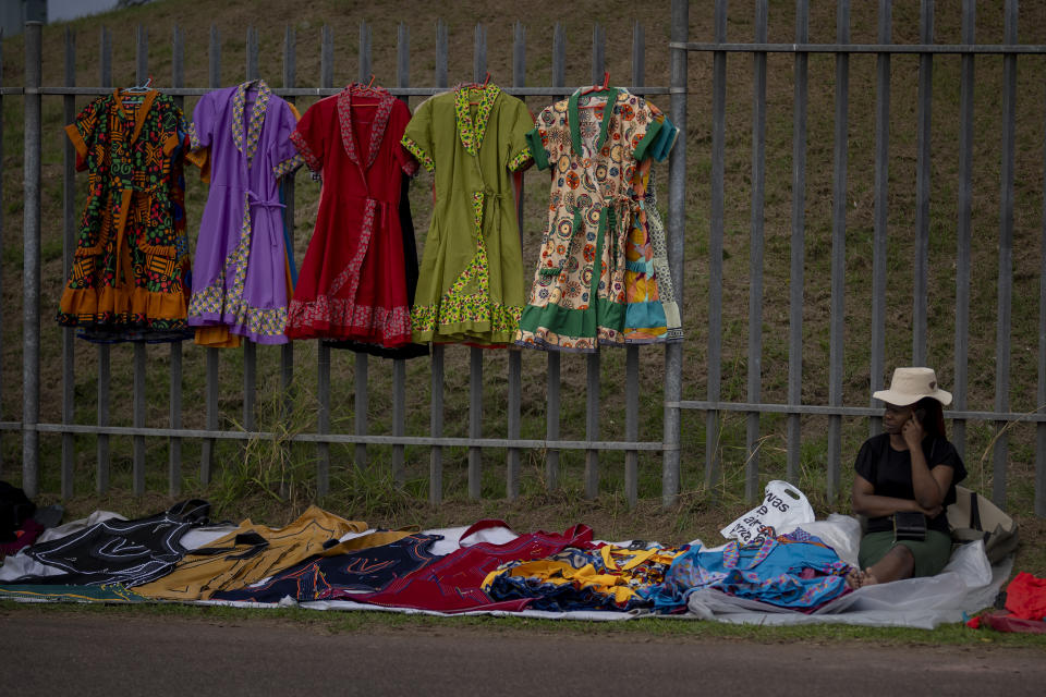 A woman sells dresses during an election meeting in Mpumalanga, near Durban, South Africa, Saturday, May 25, 2024, ahead of the 2024 general elections scheduled for May 29. (AP Photo/Emilio Morenatti)