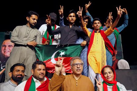 Supporters of Imran Khan, chairman of the Pakistan Tehreek-e-Insaf (PTI) party, react to a party song during a campaign ahead of general elections in Karachi, Pakistan July 6, 2018. Picture taken July 6, 2018. REUTERS/Akhtar Soomro