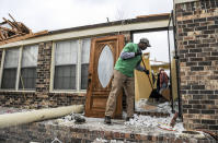 <p>Phillip Moore helps cleanup a house that was destroyed Tuesday, March 20, 2018, in Ardmore, Ala., after a violent storm went swept through the area the night before. (Photo: Jeronimo Nisa/The Decatur Daily via AP) </p>