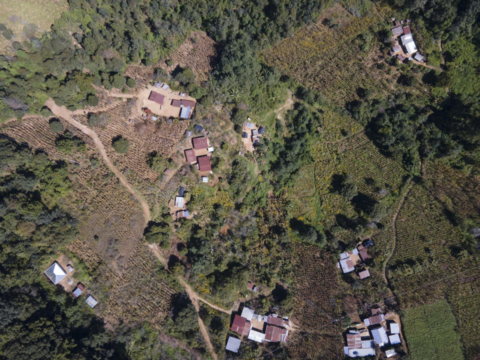 CORRECTS TO CLARIFY THAT SALVADOR TINIGUAR'S WHEREABOUTS ARE UNKNOWN - An aerial view of Salvador Mateo Tiniguar's hometown Chepol, in the western highlands of Guatemala, Saturday, Dec. 11, 2021. Salvador Mateo Tiniguar, who was migrating to the United States, was traveling on the truck that crashed in Mexico that killed 55 migrants. His family does not know what happened to him as they wait for information from Mexican authorities who have released a list of seven seriously injured unidentified people. (AP Photo/Moises Castillo)