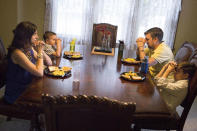 <p>Kristi Clay, left, and her husband, Bill, second from right, pray before a meal with their sons, Ami, second from left, and Xavier, at their home in Ashville, Ohio., on Saturday, July 9, 2016. Their strong Christian faith has not helped him find much inspiration in the current presidential candidates, both of whom Bill sees as self-serving and unwilling to budge on important issues. Although they both plan to vote, he says, “I’m feeling a little pessimistic this year.” (AP Photo/John Minchillo) </p>