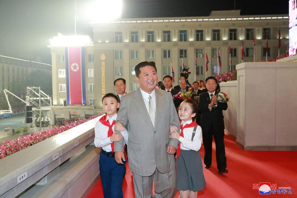Kim Jong Un walks with children during the celebration.
