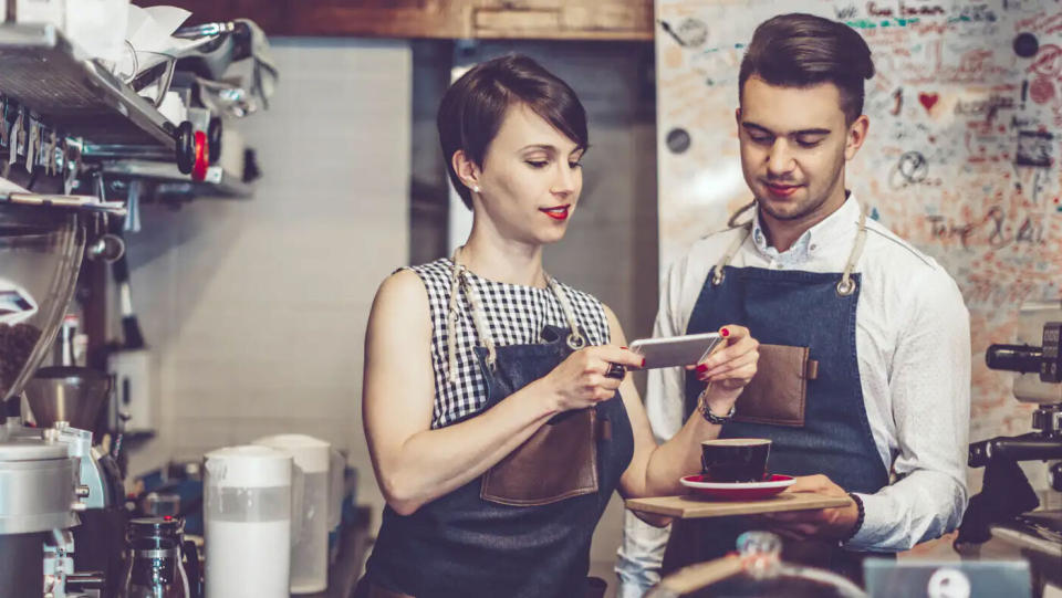 Coworker taking picture of coffee to post on social media