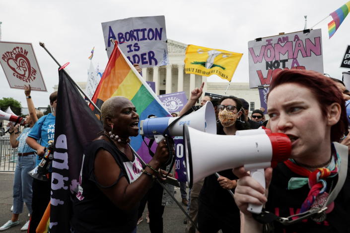 Abortion rights supporters and anti-abortion activists demonstrate outside the U.S. Supreme Court in Washington, DC, on Tuesday.  (Evelyn Hockstein / Reuters)