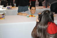 A woman takes a picture as a contestant poses with his animal creation.