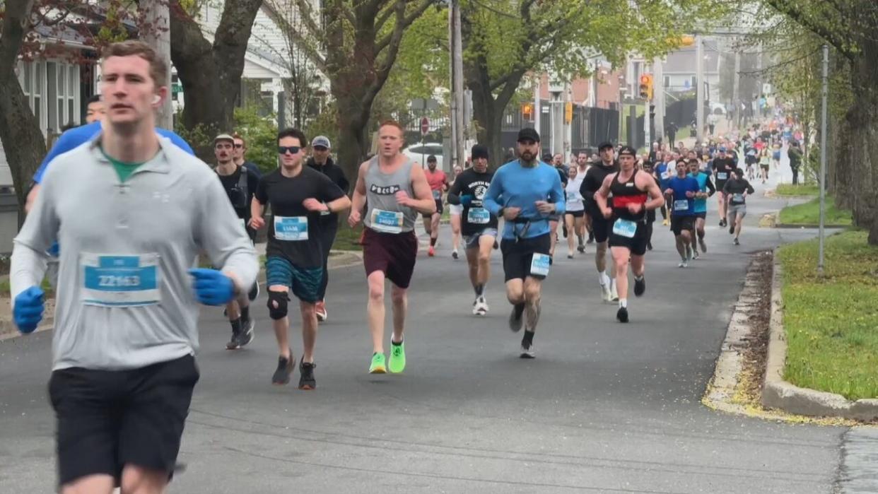 Runners race through the streets of Halifax on Sunday in the 2024 Blue Nose Marathon. (Craig Paisley/CBC - image credit)