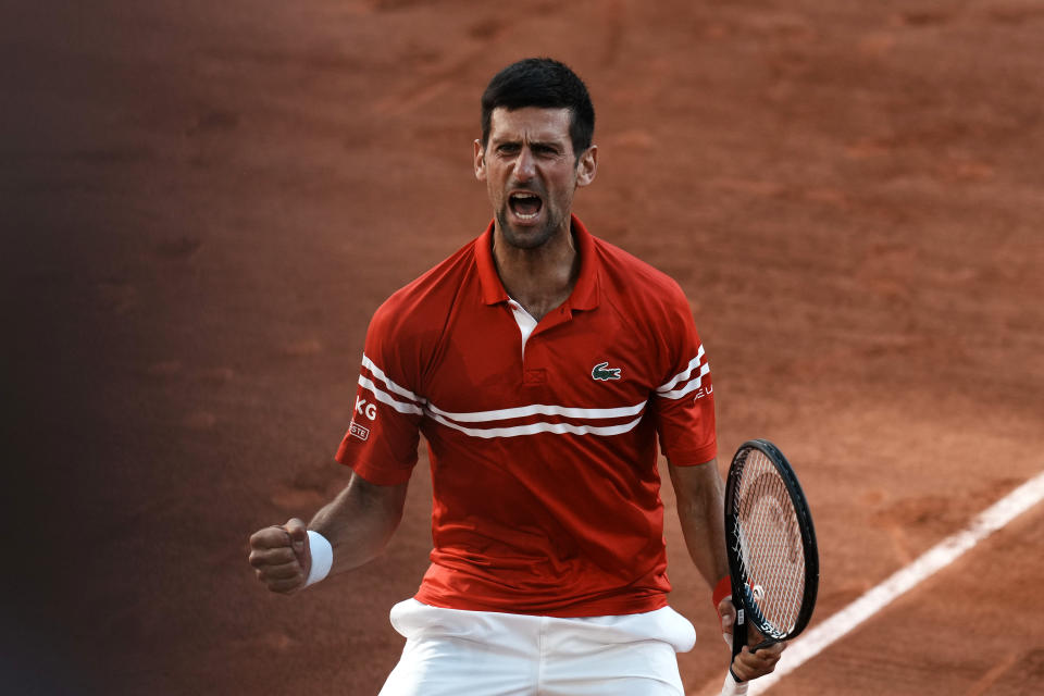 Serbia's Novak Djokovic celebrates defeating Stefanos Tsitsipas of Greece in their final match of the French Open tennis tournament at the Roland Garros stadium Sunday, June 13, 2021 in Paris. Djokovic won 6-7, 2-6, 6-3, 6-2, 6-4. (AP Photo/Thibault Camus)