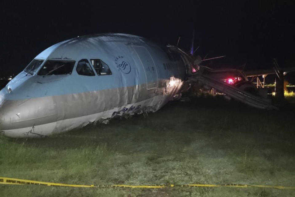 In this photo provided by the Civil Aviation Authority of the Philippines, a damaged portion of the Korean Air Lines Co. plane lies after it overshot the runway at the Mactan Cebu International Airport in Cebu, central Philippines, on Monday Oct. 24, 2022. A Korean Air Lines Co. plane overshot a runway while landing in bad weather in the central Philippines late Sunday and authorities said all those on board were safe. The airport is temporarily closed due to the stalled aircraft. (Civil Aviation Authority of the Philippines via AP)