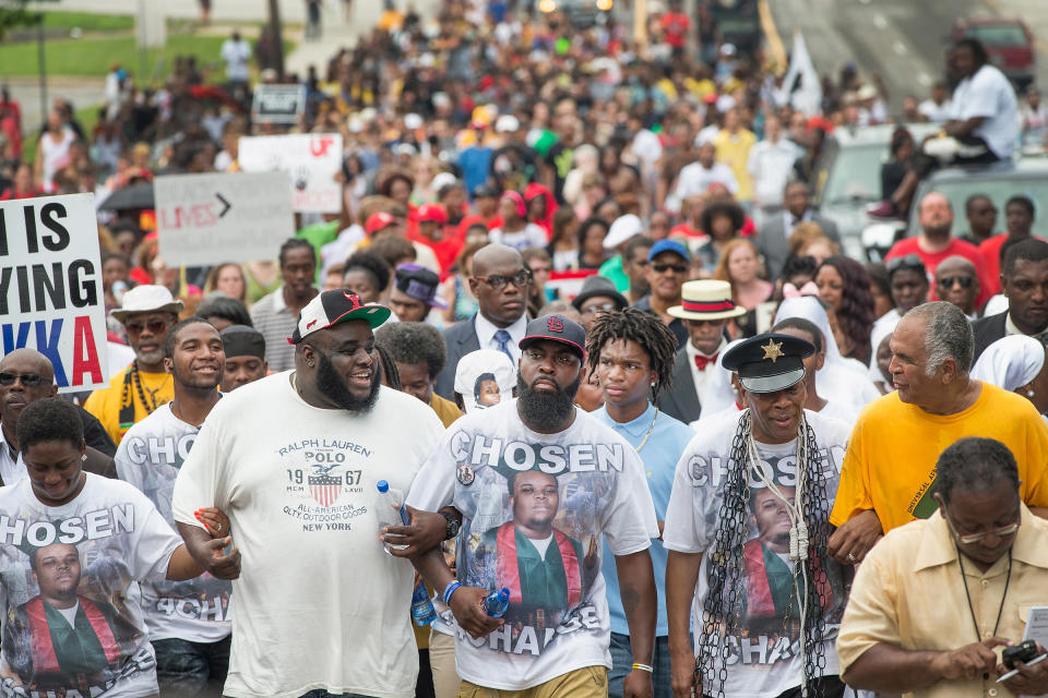 Michael Brown Sr. (center) leads a march from the location where his son Michael Brown Jr. was shot and killed following a memorial service marking the anniversary of his death in Ferguson, Mo. on Aug. 9, 2015. | Scott Olson—Getty Images