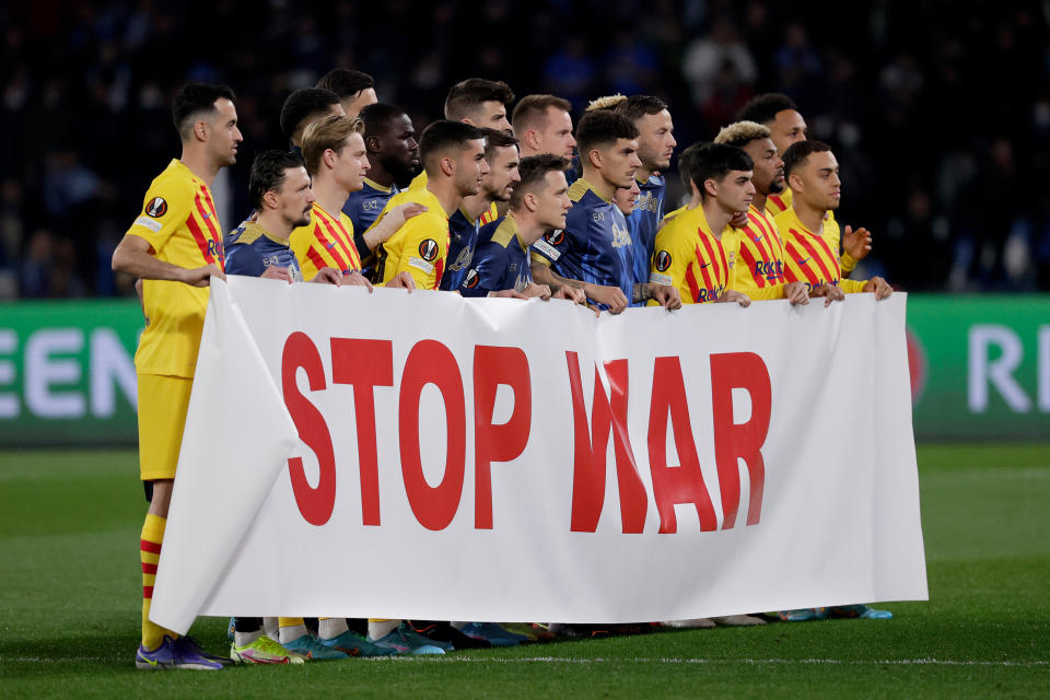 FC Barcelona and SSC Napoli unite with a 'Stop War' banner during the UEFA Europa League.