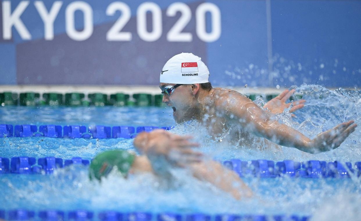 Singapore swimmer Joseph Schooling trailing during his men's 100m butterfly heat at the 2020 Tokyo Olympics.