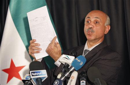 Abdeltawwab Shahrour, head of the forensic medicine committee in Aleppo, shows forensic reports, during a news conference in Istanbul September 10, 2013. REUTERS/Murad Sezer