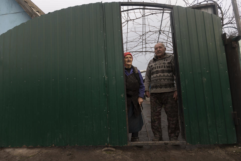 Kateryna Shklyar and her husband, Dmytro, talk with Associated Press journalists at their house in the village of Nevelske, in eastern Ukraine, on Friday, Dec. 10, 2021. With the bloody conflict between Russia-backed separatists and Ukrainian forces now more than seven years old, there are fears that a buildup of armed forces on Russia's side of the border could lead to an invasion or the resumption of full-scale hostilities. “We don't want war!" she exclaimed. (AP Photo/Andriy Dubchak)