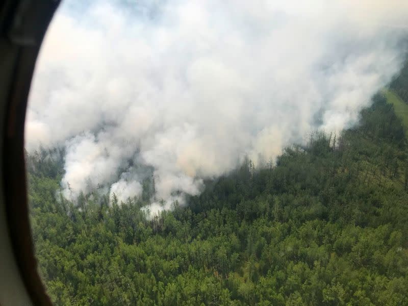 An aerial view shows smoke rising from a forest fire burning in Yakutia