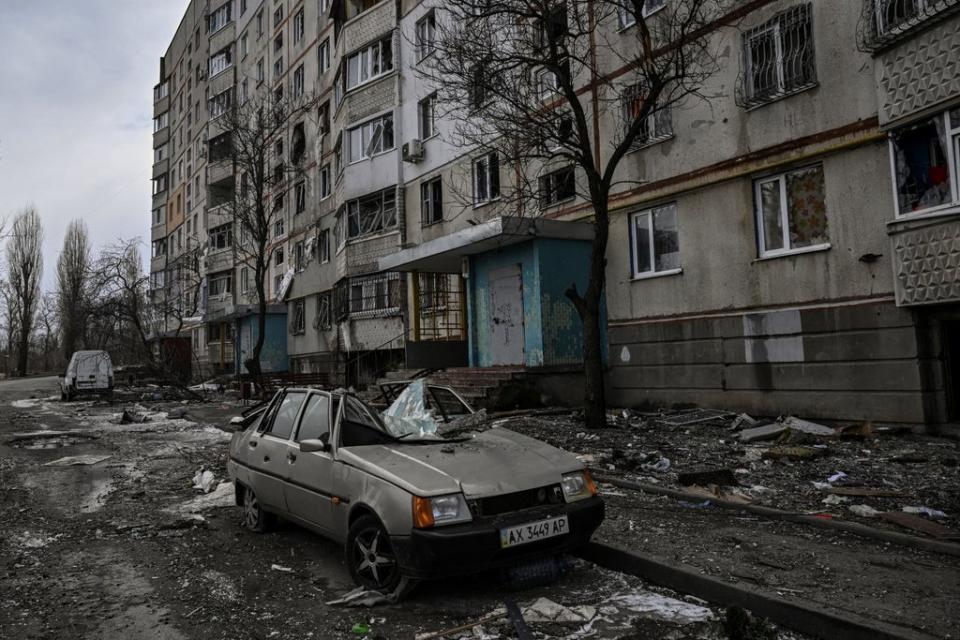 A destroyed car near a damaged apartment building in Kharkiv (AFP/Getty)