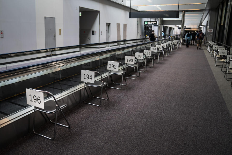 Chairs are numbered in the holding area for foreign visitors at the Narita International Airport on July 10, 2021, in Narita, near Tokyo. Japan’s massive security apparatus for the upcoming Summer Olympics is raising complaints that the nation, during the weeks of the Games, will look more like authoritarian North Korea or China than one of the world’s most powerful, vibrant democracies. (AP Photo/Jae C. Hong)