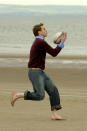 <p>Prince William catching a rugby ball on the beach at St Andrews. He and Kate will return to the beach during their week-long tour as they revisit their student days. (PA Images)</p> 