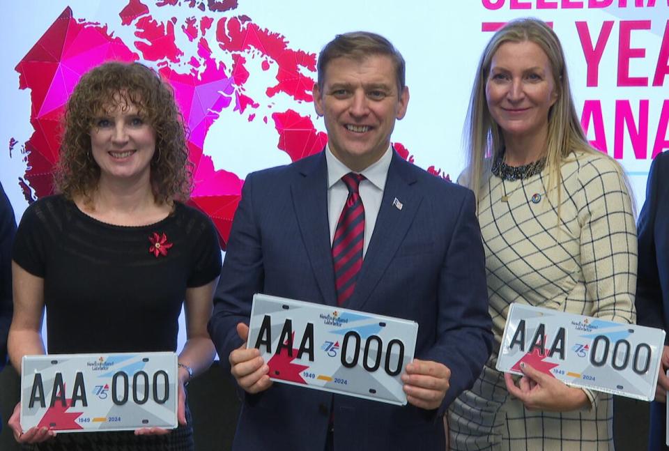 From left: Hillary Coombs of the Newfoundland and Labrador Historical Society, Premier Andrew Furey and Cheryl Hickman of Opera on the Avalon hold the new license plate that will mark the 75th anniversary of confederation.