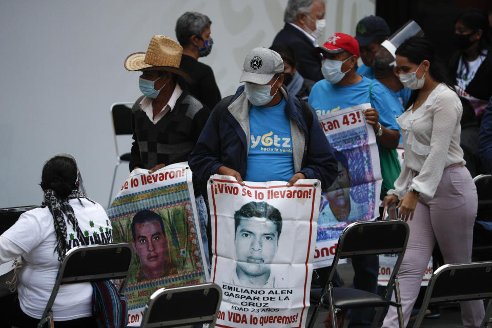 Family members of 43 missing teachers college students carry images of their missing sons, as they arrive for an update to the ongoing investigation on the sixth anniversary of the students' enforced disappearance, at the National Palace in Mexico City, Saturday, Sept. 26, 2020.(AP Photo/Rebecca Blackwell)