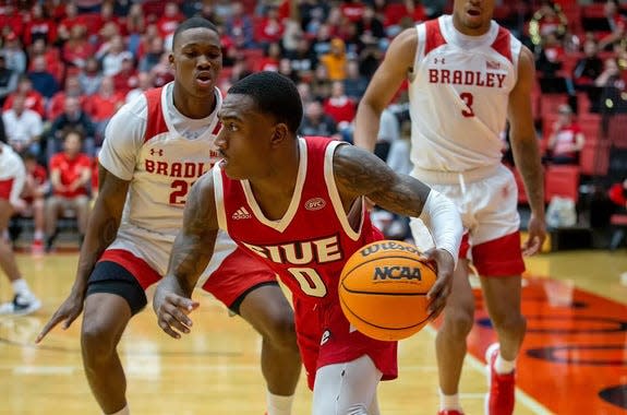 Bradley guard Duke Deen (21) and wing Zek Montgomery (3) hem in Damarco Minor during a 56-54 win over Southern Illinois University-Edwardsville at First Community Arena on Tuesday, Dec. 6, 2022.