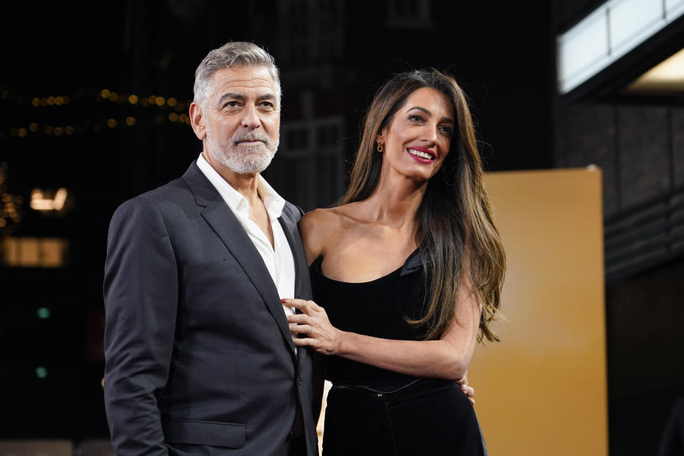FILE - George Clooney and his wife Amal Clooney pose for photographers upon arrival at the screening of the film "The Boys In The Boat," Dec. 3, 2023, in London. Amal Clooney is one of the legal experts who recommended that the world's top war crimes court seek arrest warrants for Israeli Prime Minister Benjamin Netanyahu and leaders of the militant Hamas group, Clooney announced Monday, May 20, 2024. (Photo by Alberto Pezzali/Invision/AP, File)